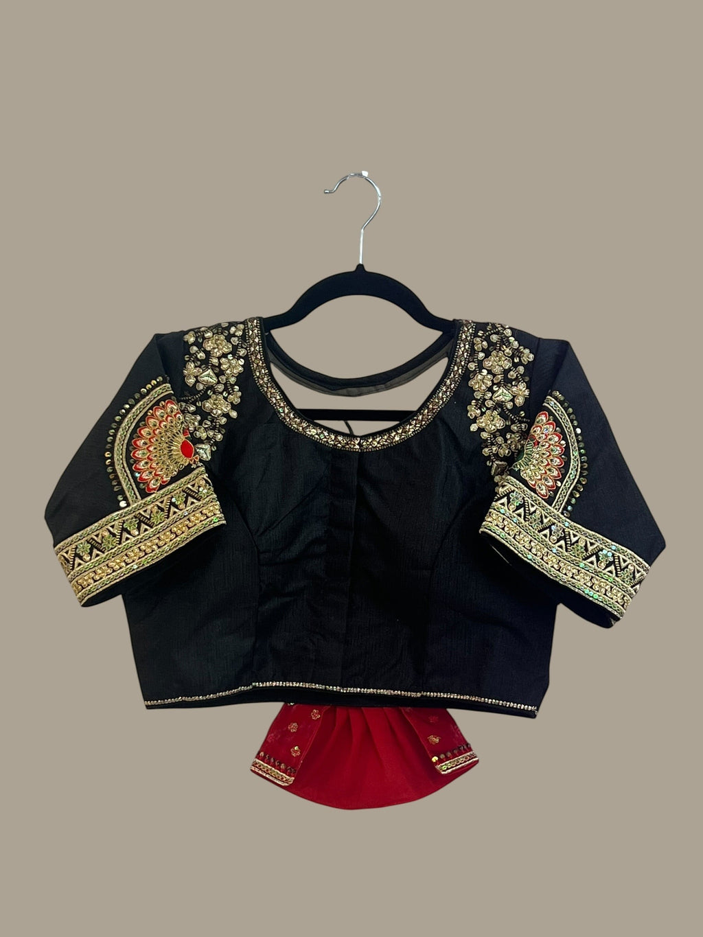 House Of Indian Wedding Attire black blouse with intricate gold, red, and green embroidery on neckline and sleeves.