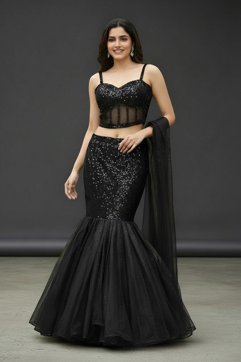 House Of Indian Wedding Attire black shimmer lehenga with corset blouse and flared tulle skirt. Model wears a strappy, sweetheart neckline top.