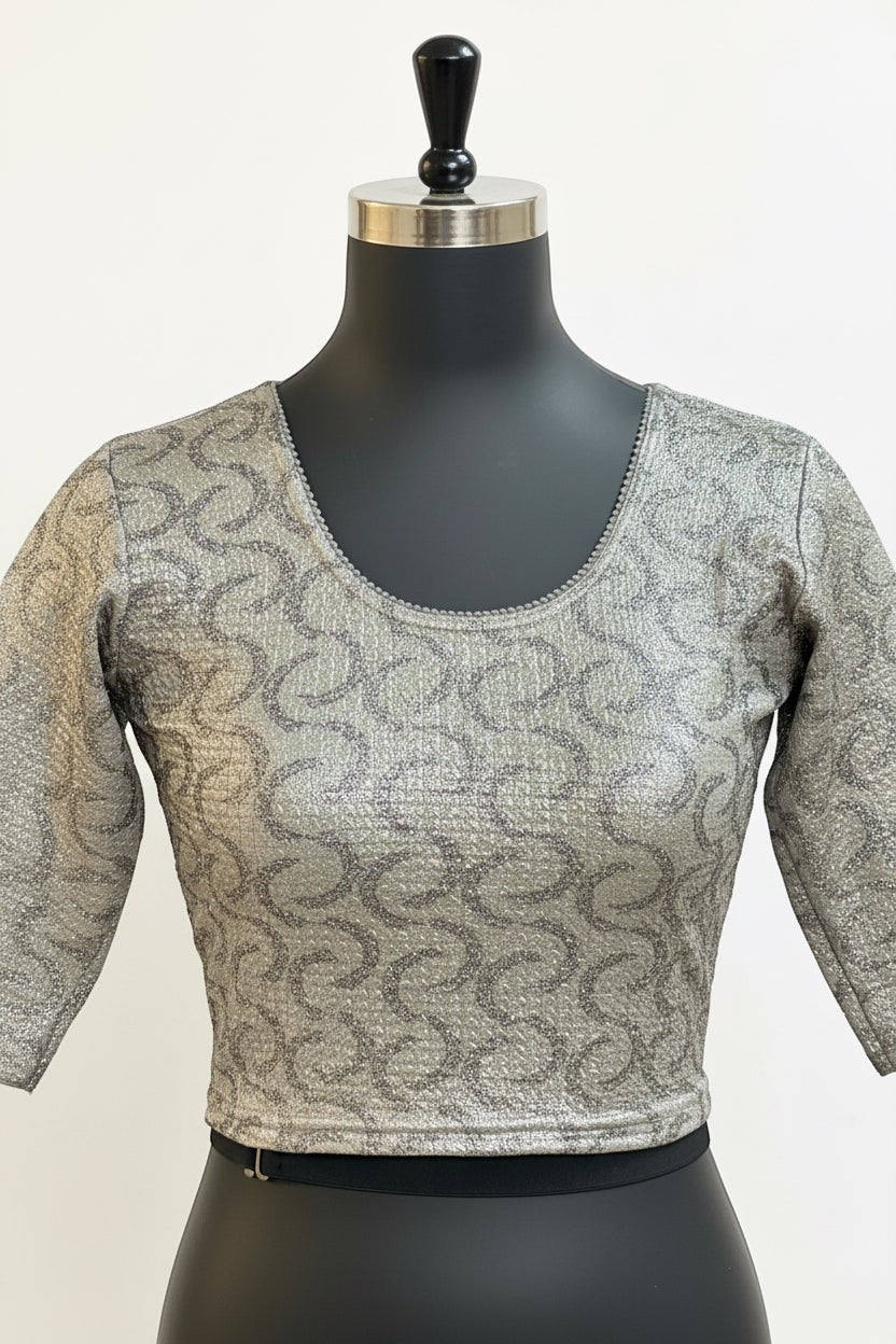 House Of Indian Wedding Attire silver stretchable blouse with a swirling pattern and beaded neckline.
