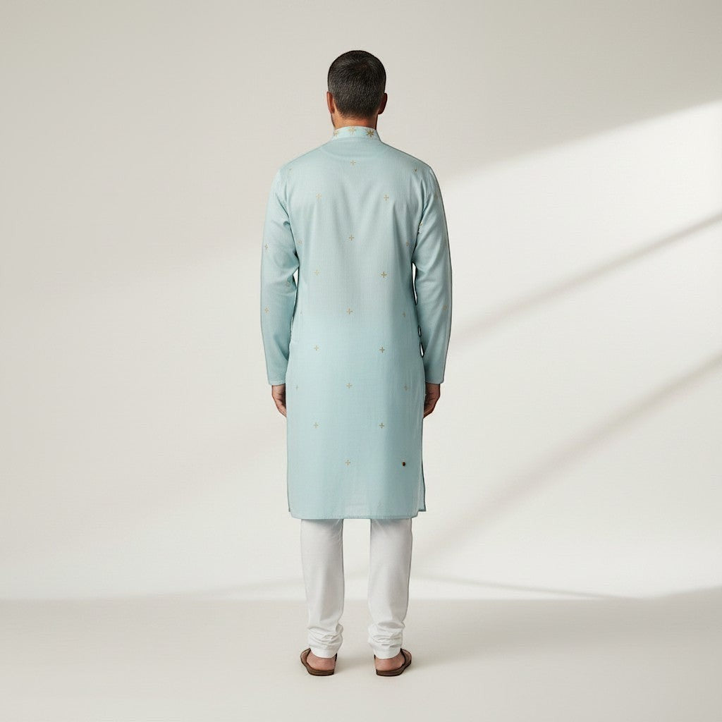 Kurti Connection USA light blue silk kurta set with subtle gold embroidery and white pajama, worn by a man.