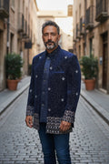 Kurti Connection USA navy blue Bandhgala jacket with silver embroidery and patterned cuffs. Model wears it with a blue shirt and jeans.