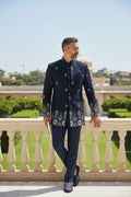 Kurti Connection USA navy blue embroidered Bandhgala suit with silver and white detailing on collar, cuffs, and hem. Tailored fit.