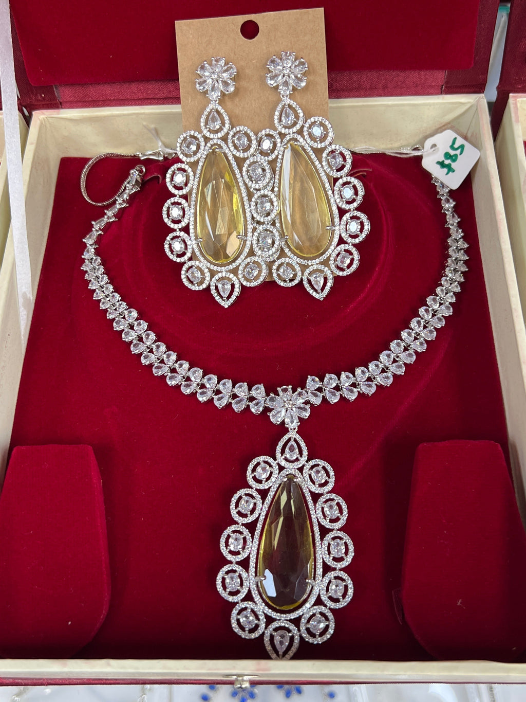 Kurti Connection USA statement necklace set with teardrop yellow stones and clear crystals, matching dangle earrings.